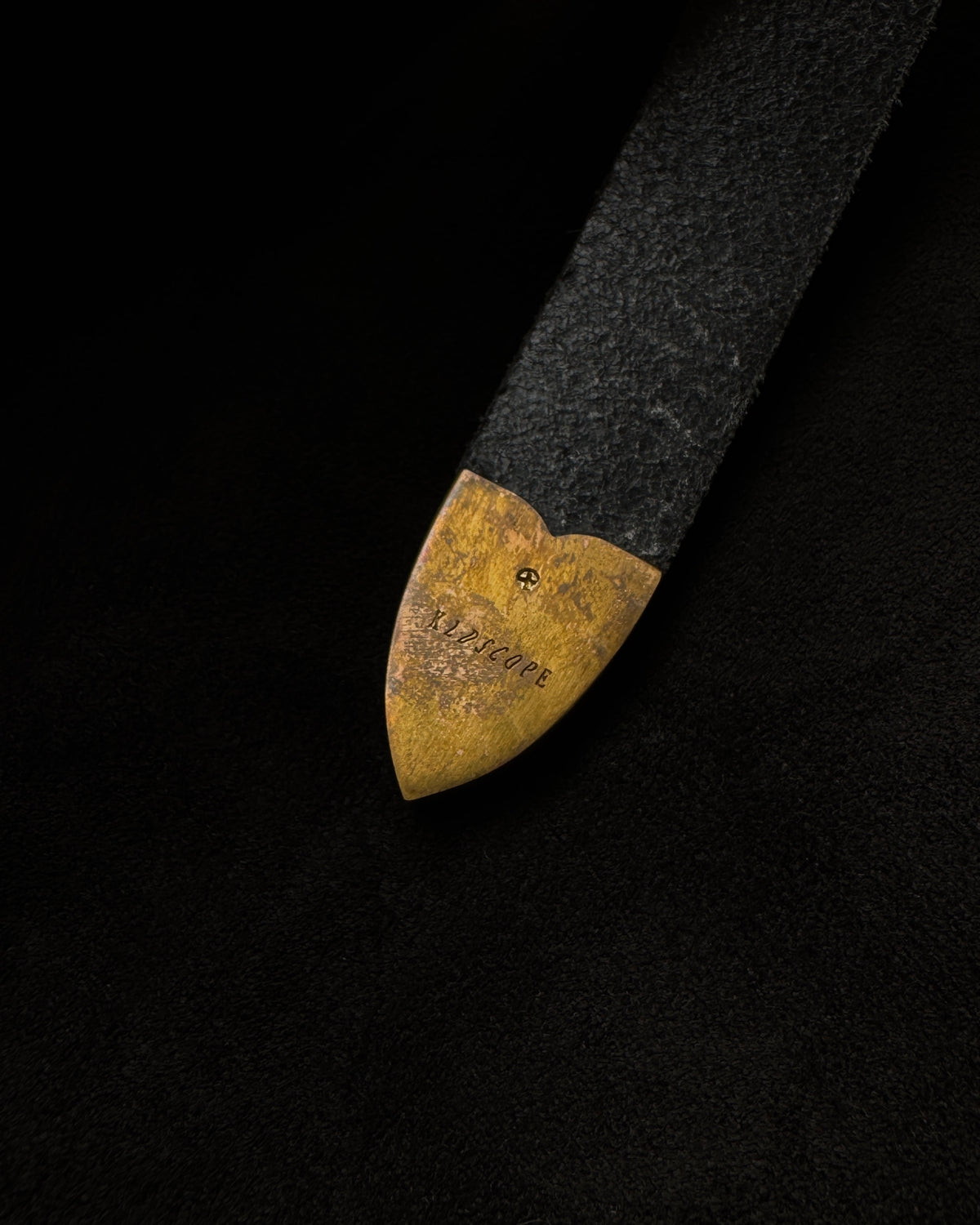 Close-up of the JOEY solid brass tip showing natural darkening and tonal variation.