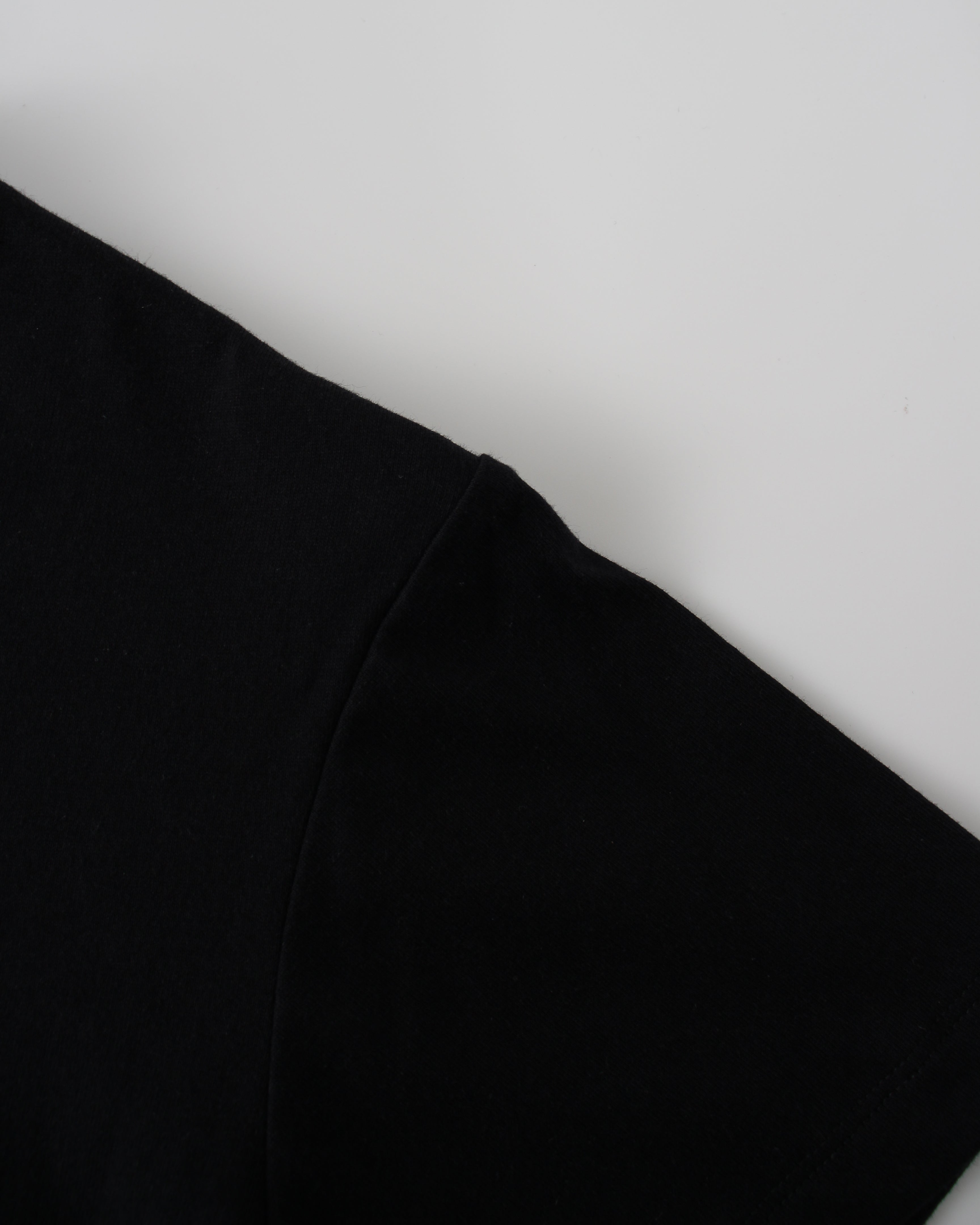 Black fabric tee shoulder on a white background
