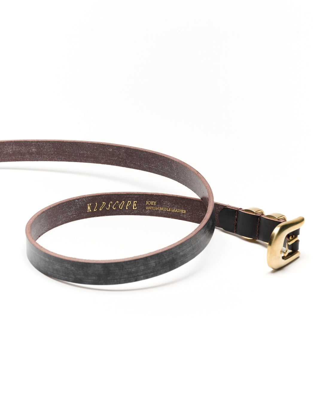 A dark brown leather belt with a textured finish, featuring a gold-tone buckle and a gold-embossed brand name 'KIOSCOPE' on the inner strap, displayed on a clean white background.