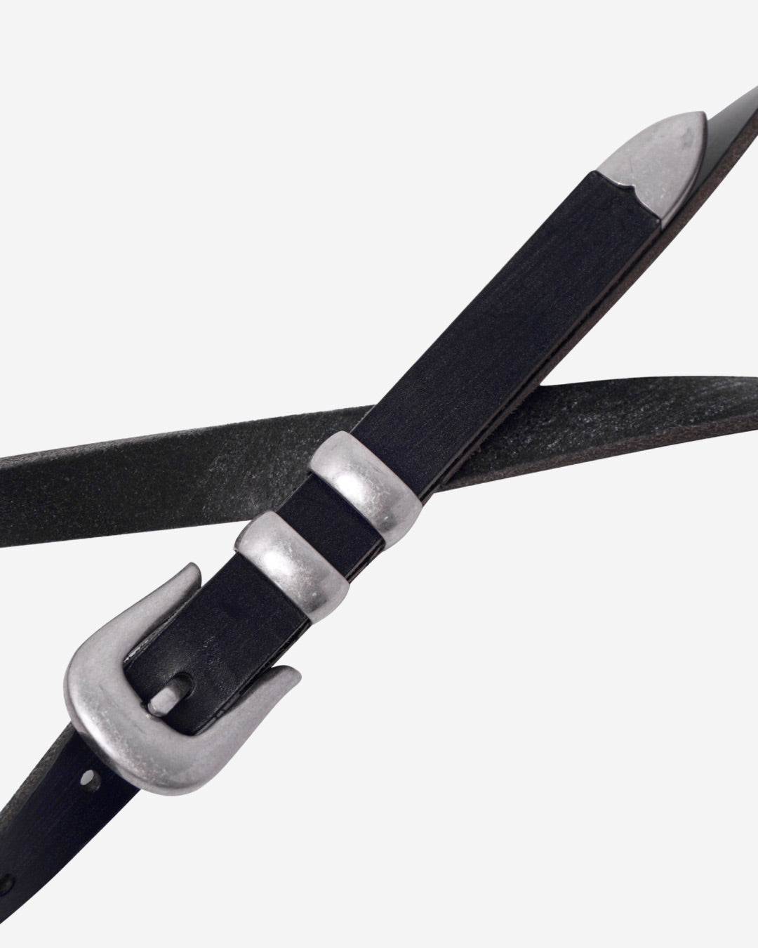 Image of a stylish black leather Western belt with metallic tips and buckles, placed on a white surface.