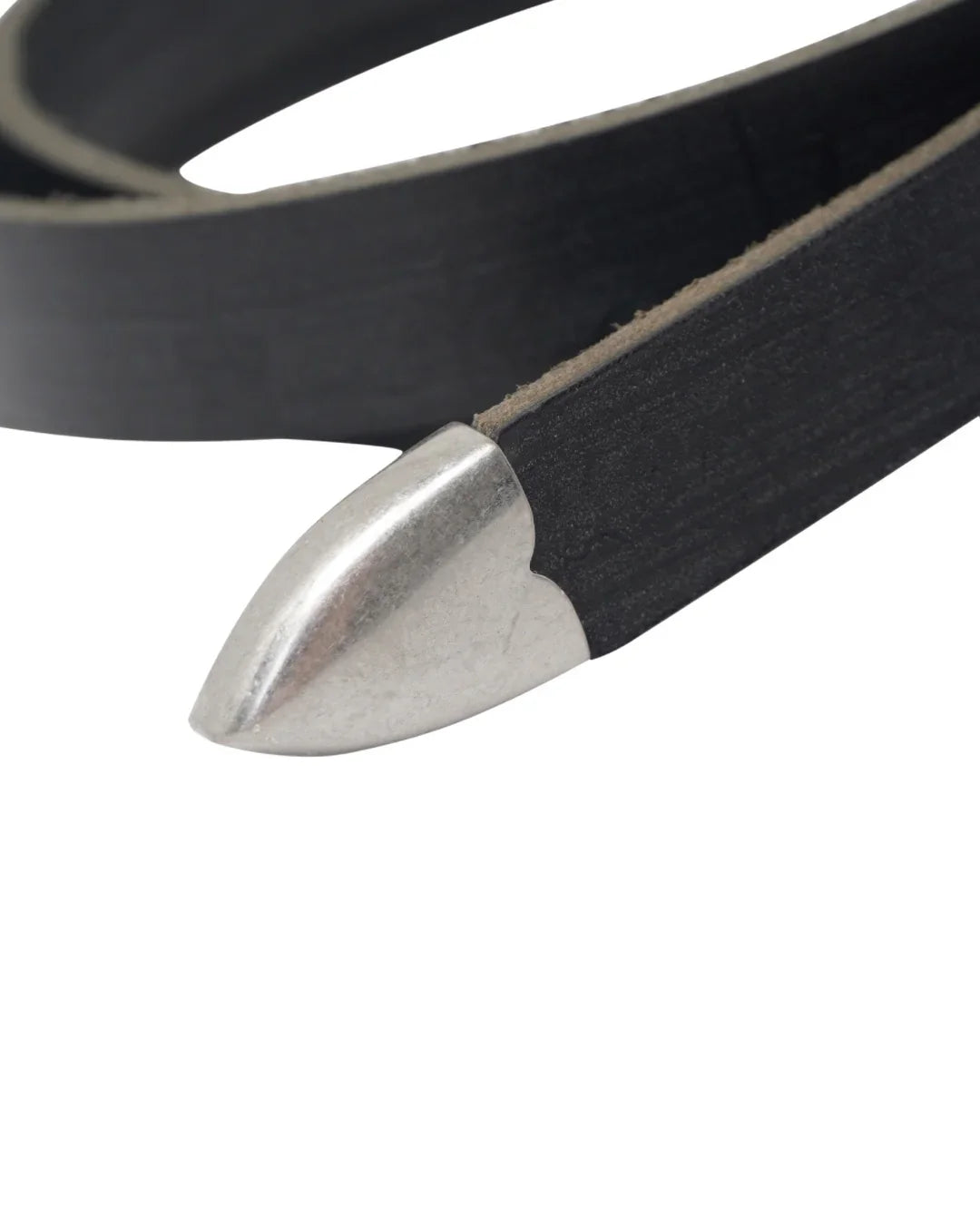 Image of a stylish black leather Western belt's metallic tips close up, placed on a white surface.