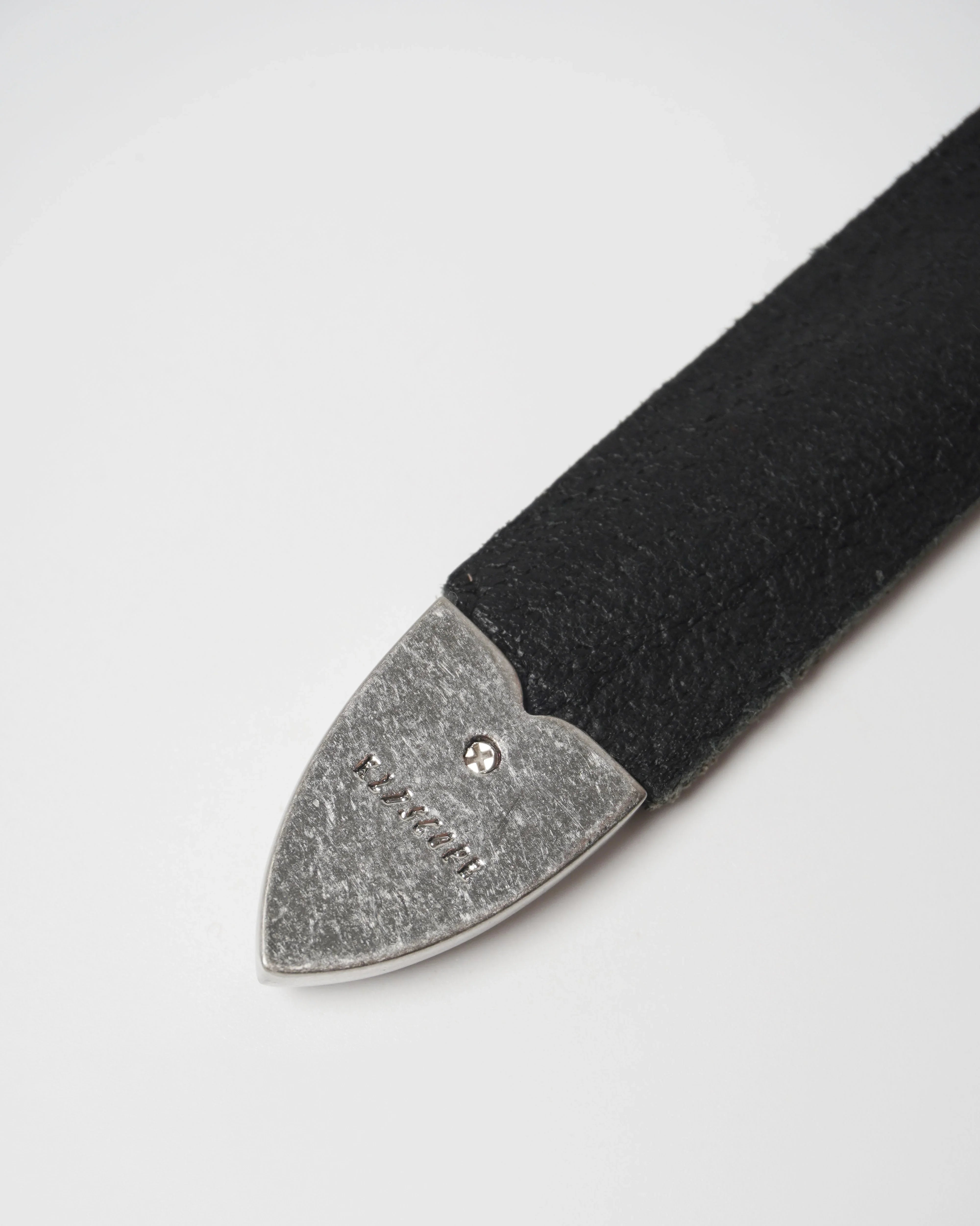Image of a stylish black leather Western belt metallic tips placed on a white surface.