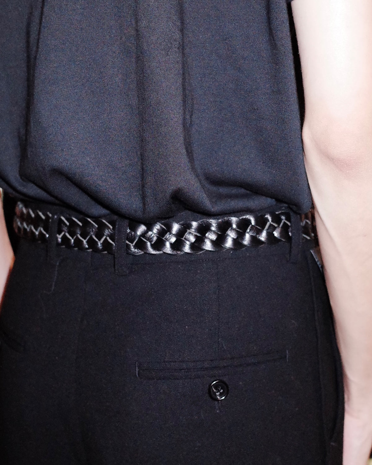Deep black matte Western belt by KLDSCOPE with braided leather, styled on men’s trousers with a tucked-in shirt, a sleek fashion accessory, shop now.