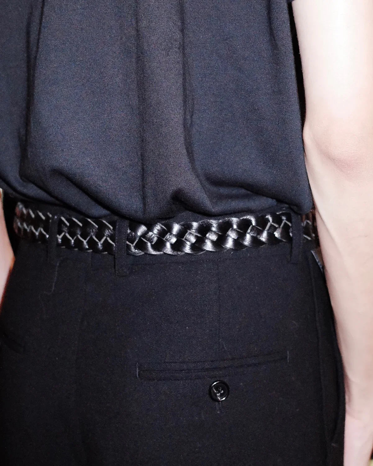 Deep black matte Western belt by KLDSCOPE with braided leather, styled on men’s trousers with a tucked-in shirt, a sleek fashion accessory, shop now.