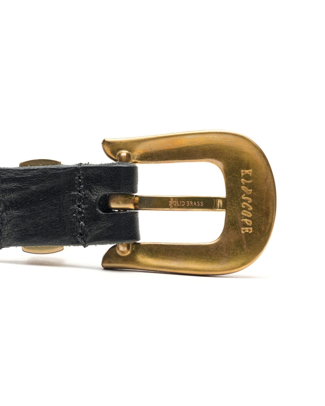 Close-up of a KLDSCOPE JOEY buckle engraved in SOLID BRASS, showing natural tonal variation.