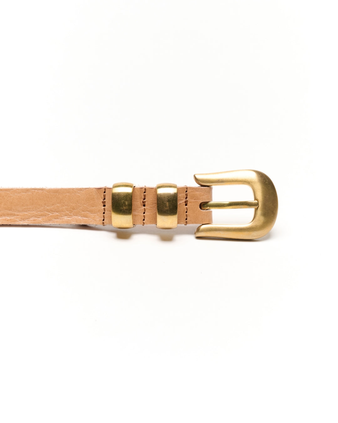 A close-up of a light tan leather Western belt with a polished gold-tone metal buckle and keeper loops, shown on a clean white background.