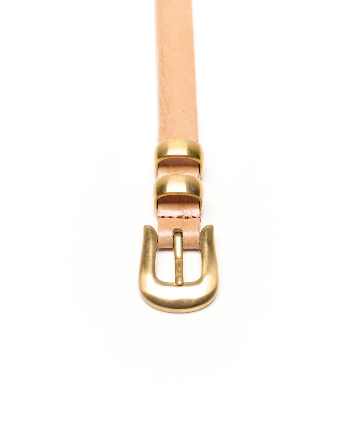 A close-up of a light tan leather Western belt with a polished gold-tone metal buckle, shown against a plain white background.