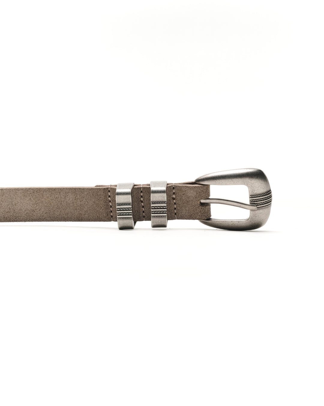 A close-up of a sand-grey leather Western belt with a polished silver-tone metal buckle and keeper loops, shown horizontally against a plain white background.